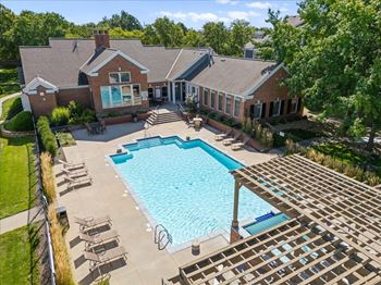 A large house with a pool in the backyard. at Somerset Oaks Apartment Homes, Olathe 66062